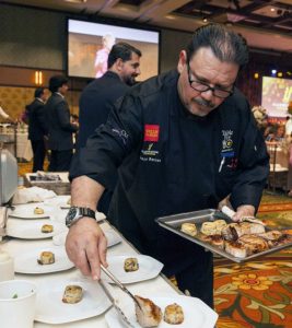 Chef Franco Barone prepares cuisine at a charity wine dinner