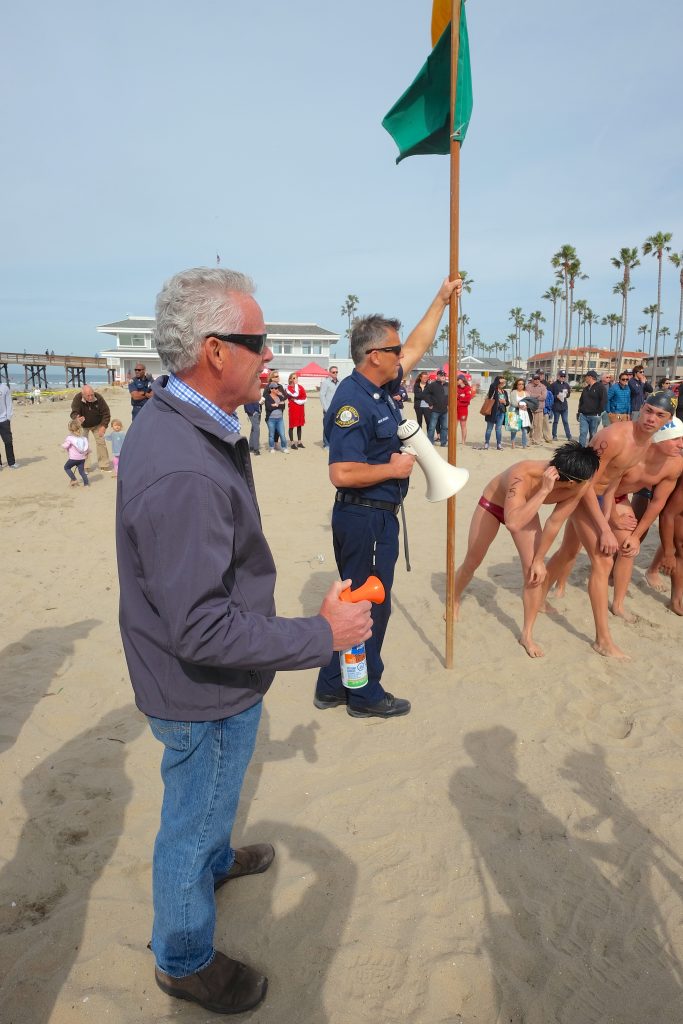 Councilman Brad Avery prepares to blow the air horn to kick off the beach race. — Photo by Jim Collins ©