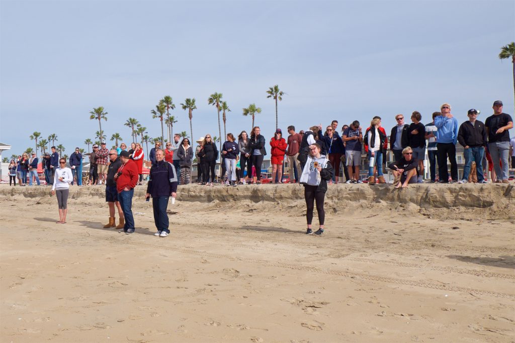 People watch the race from the sidelines on the beach. — Photo by Jim Collins ©