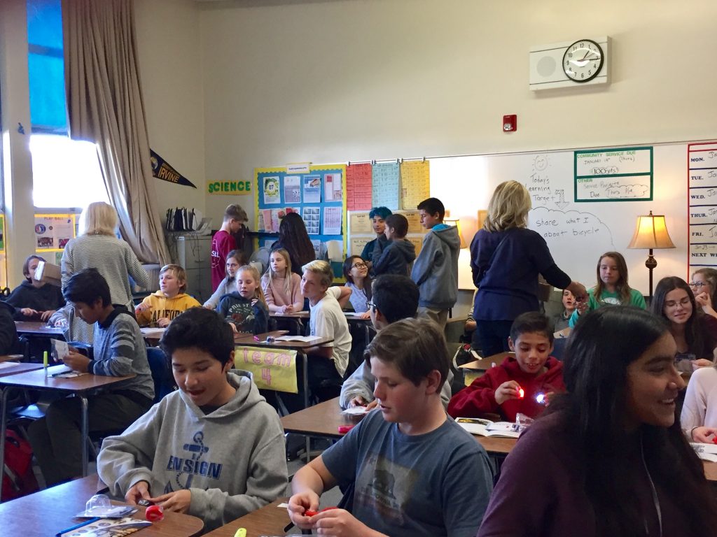 Children receive front and rear bike lights and safety guide prior to a presentation from the Newport Harbor Elks Lodge about bicycle safety.  — Photo courtesy of Karen Johnson  ©