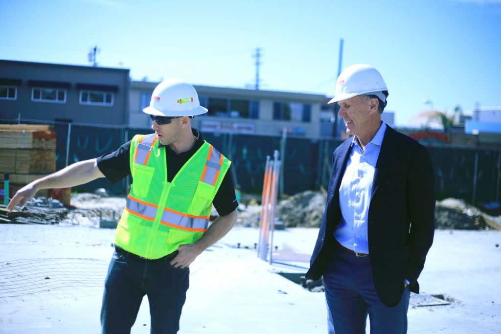 Bob Olson (right), President & CEO of R.D. Olson Development, and Jeremy Dunn, Project Engineer for Lido House Hotel, explain some of the features of the boutique hotel that is part of the overall revitalization plan for Lido Village and the Balboa Peninsula. — Photo by Sara Hall ©