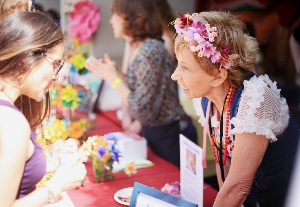Bernadette Senn, who hosts the Poland booth, talks to guests about food and culture. — Photo by Sara Hall ©
