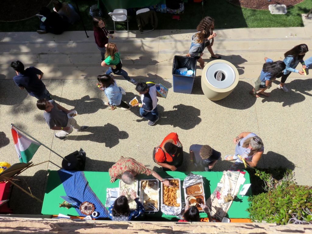 People walk by food booths at the 16th Annual Sage Hill Multicultural Fair on Saturday.  — Photo by Sara Hall ©