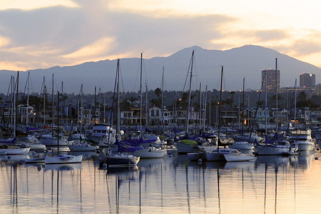 The sun rises over the moorings in Newport Harbor.  — Photo by Sara Hall ©