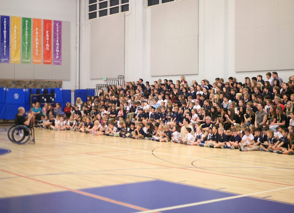 Motivational speaker Spencer West talks to a crowd of about 250 Harbor Day students, staff and parents last week.  — Photo by Sara Hall ©