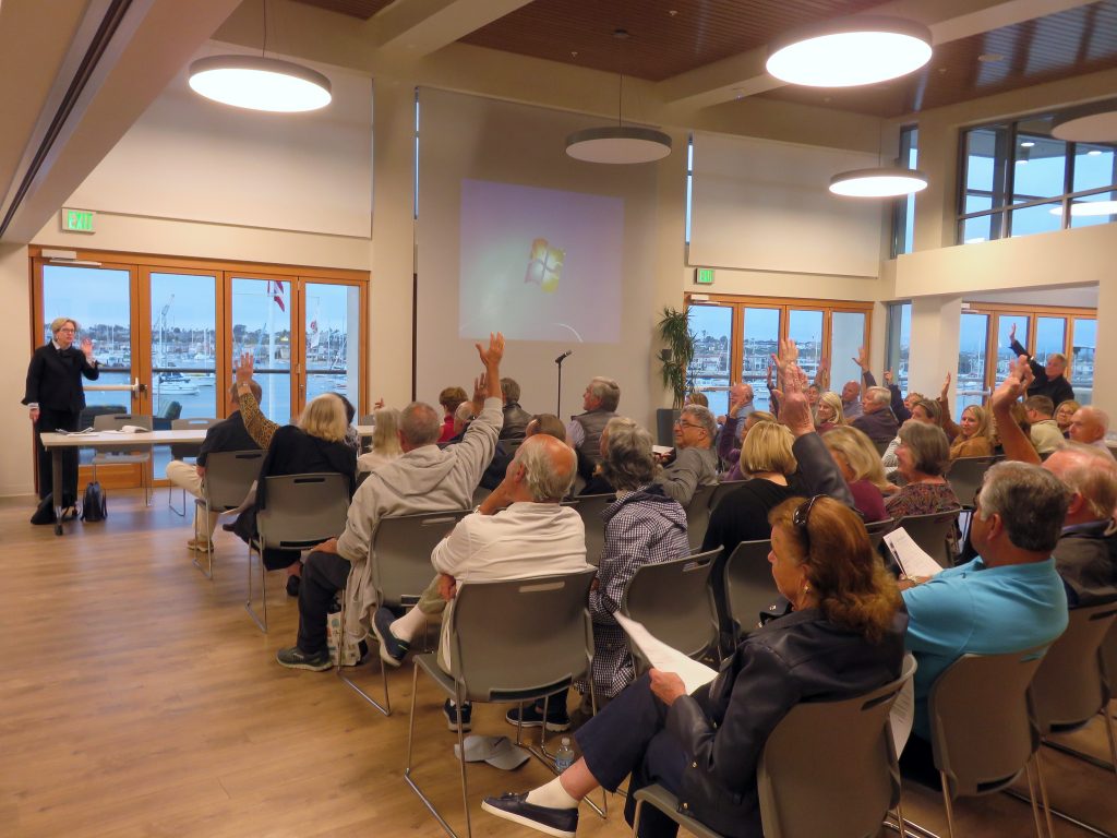 About one-third of the crowd raises their hands in support of stronger boardwalk usage rules after Councilwoman Diane Dixon (front left) asked what local residents in the audience would like to see done. — Photo by Sara Hall ©