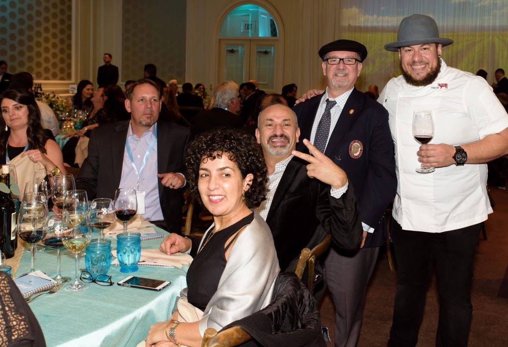 Wine curator Michael Jordan and Chef Amar Santana (standing) with guests