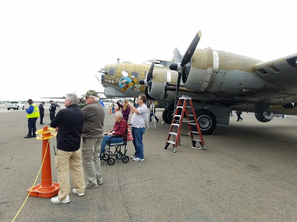 People watch as one of the historic Wings of Freedom planes takes off on Wednesday. — Photo by Jim Collins ©