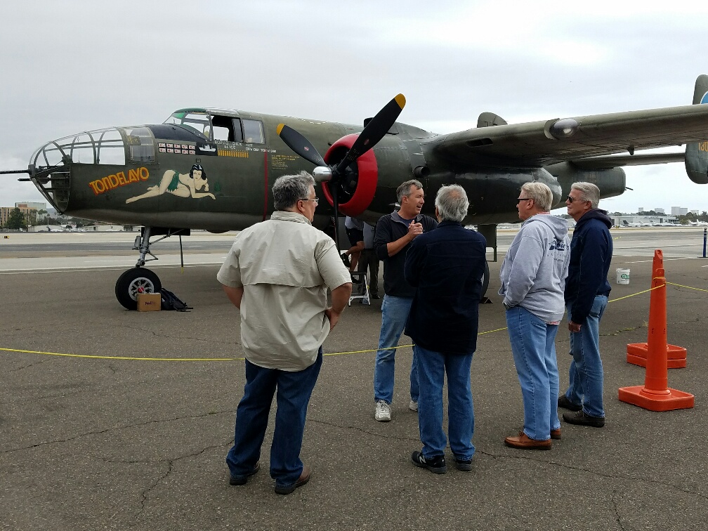 A Lyons Air Museum volunteer talks to guests about the flight experience with the Collings Foundation Wings of Freedom Tour. — Photo by Jim Collins ©