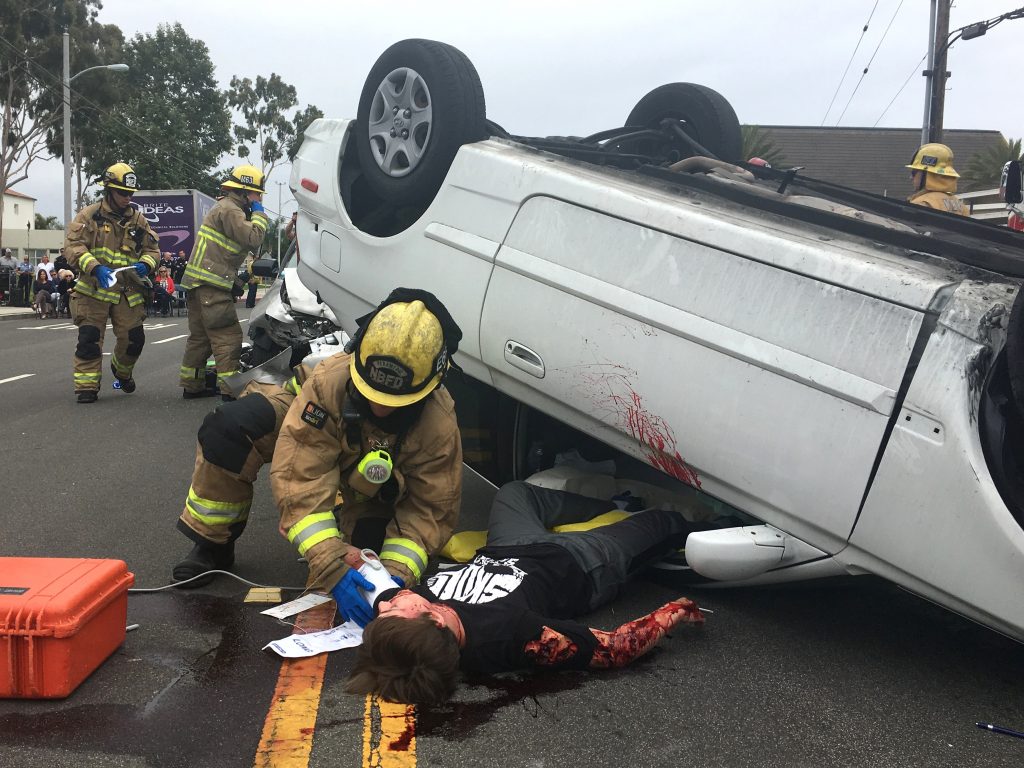 A student participant is removed from a vehicle during the “Every 15 Minutes” simulated collision on Wednesday. — Photo courtesy of Newport Beach Fire Department ©