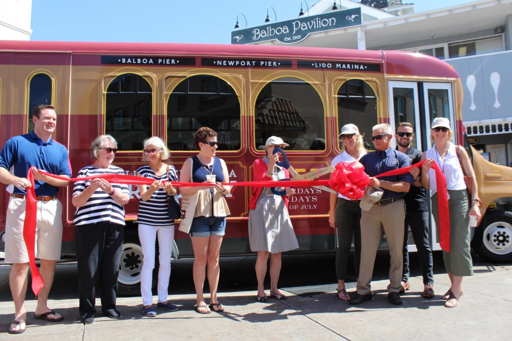 Councilmember Diane Dixon (center) cuts the ribbon marking the launch of the Balboa Peninsula Trolley