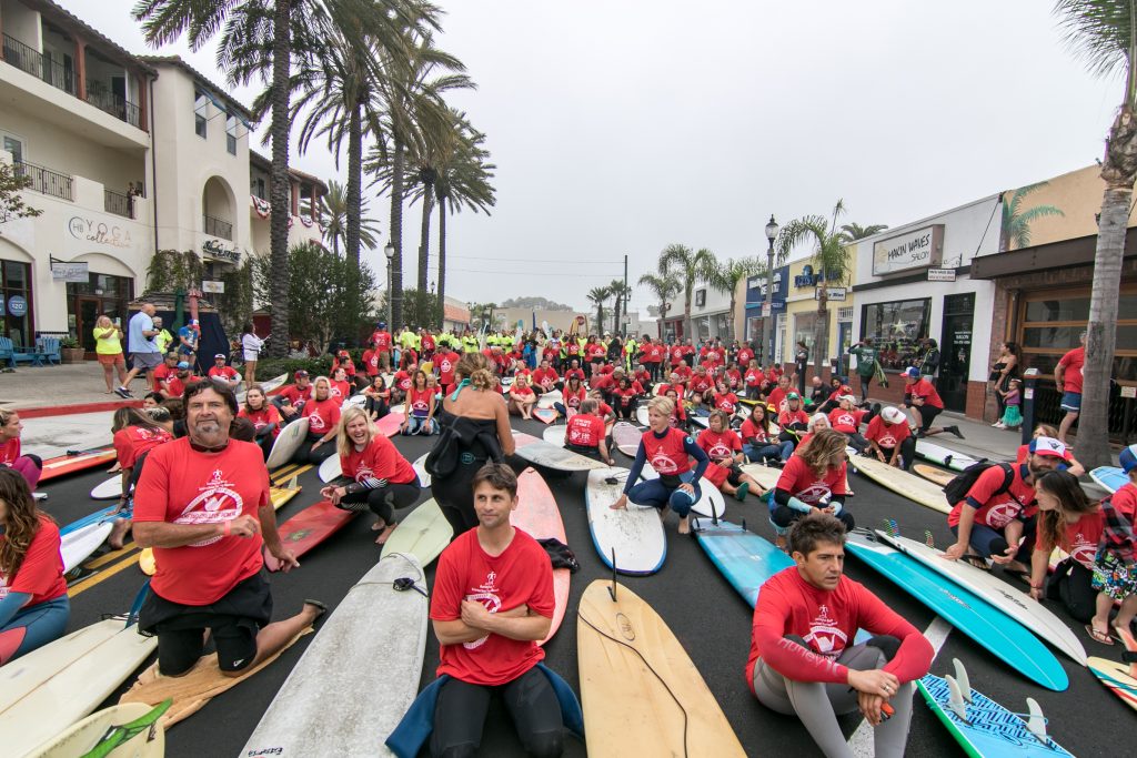 Hundreds of surfers wait in the street before heading out into the water. — Photo by Jim Collins ©