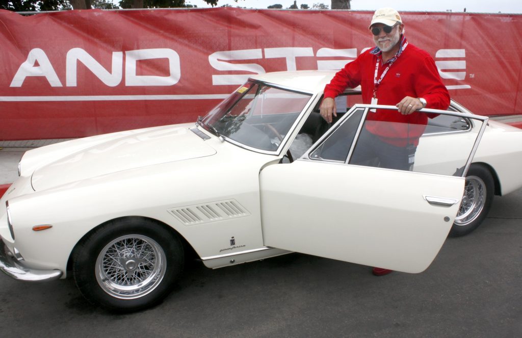 Russo and Steele owner Drew Alcazar with a 1964 Ferrari 330 GT 2+2 (Enzo Ferrari’s personal car) that goes on the auction block this weekend at Newport Dunes. — Photo by Christopher Trela ©